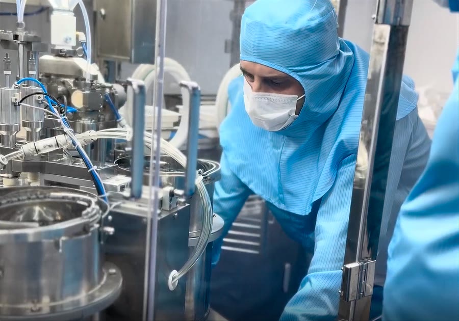 A specialist working in a clean laboratory